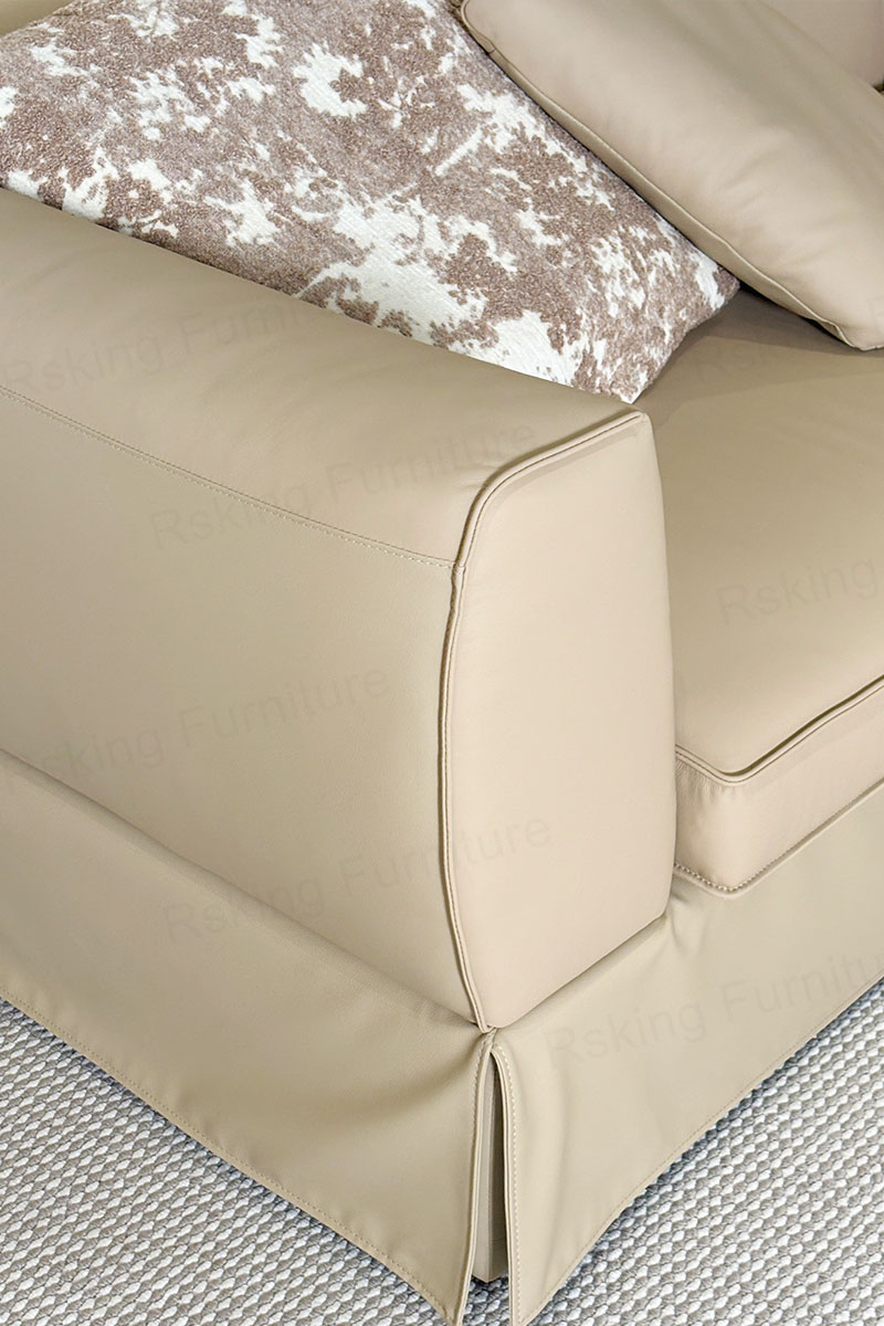Close-up of the Rsking RSK2606 beige leather arm edge, piping and seat cushion