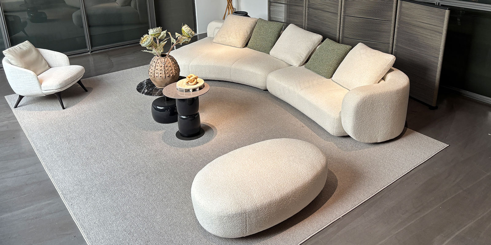 Elevated angled view of the Rsking RSK2560 sofa and matching oval ottoman showing the curved seating layout