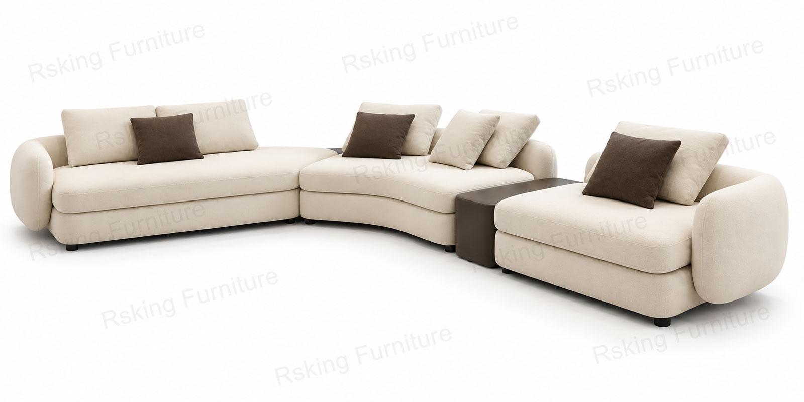 Opposite angled view of the cream curved sofa with broad cushions, layered pillows and short dark legs