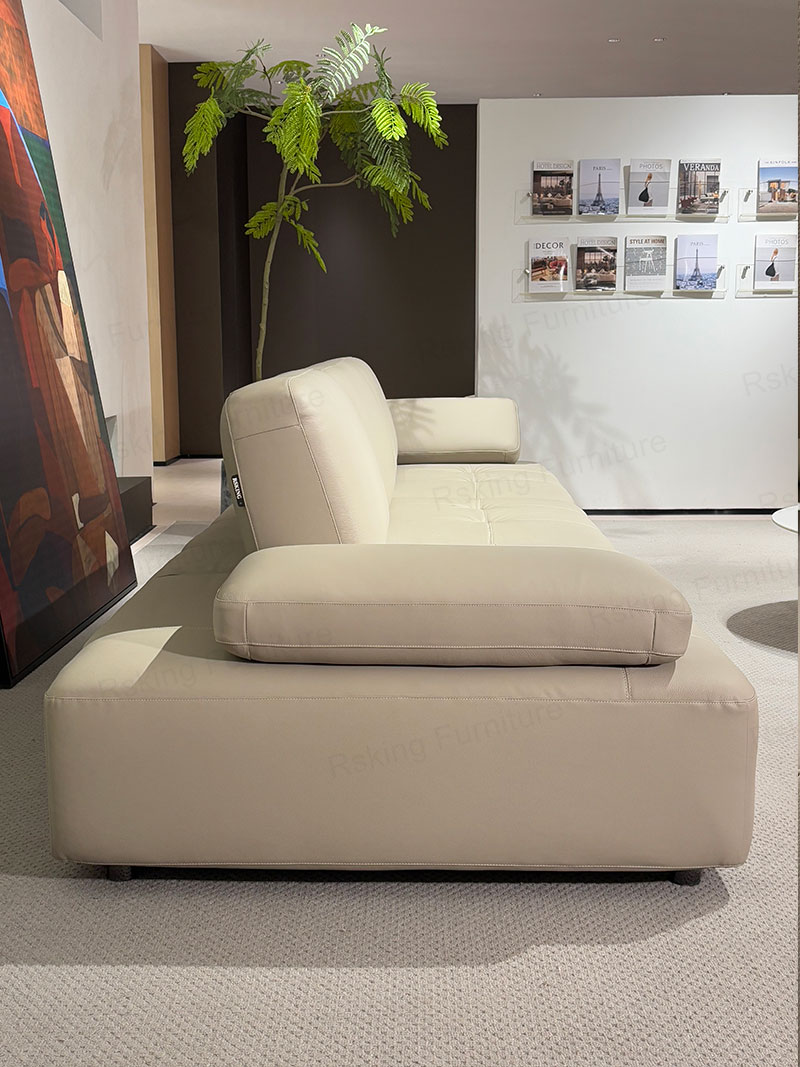 Side profile of the Rsking RSK13-B low-profile leather sofa with a wide armrest and short cylindrical legs