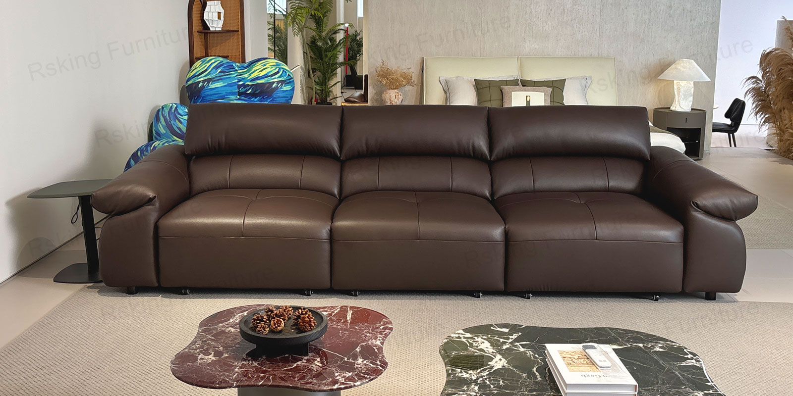 Front showroom view of the dark brown leather sofa with seats retracted and layered back cushions