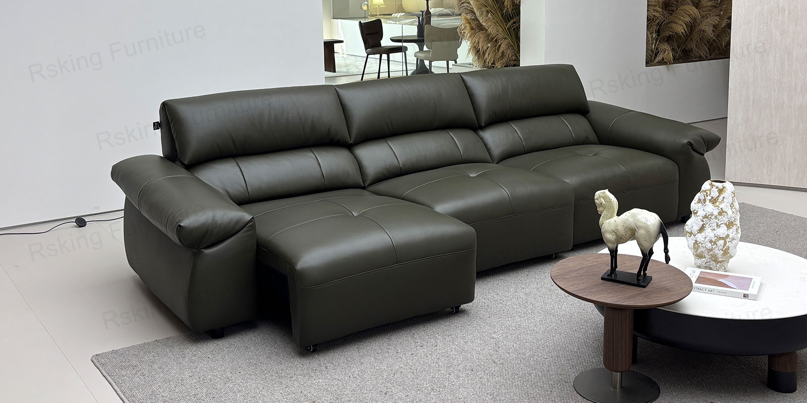 Side view of the dark brown sofa showing its rounded padded arm, upholstered base and short dark feet