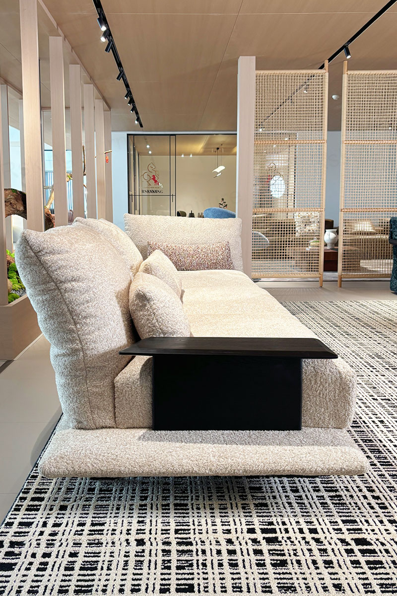 Side view of the RSK2661 sofa showing the smoked wood armrest and extended upholstered platform base