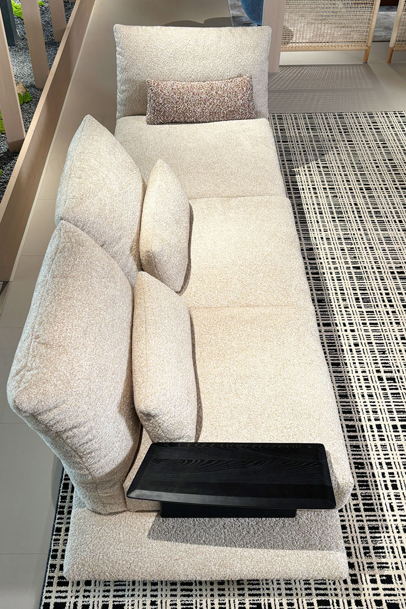 Elevated view of the chenille sofa showing segmented seats, lumbar pillows and the flat wood armrest