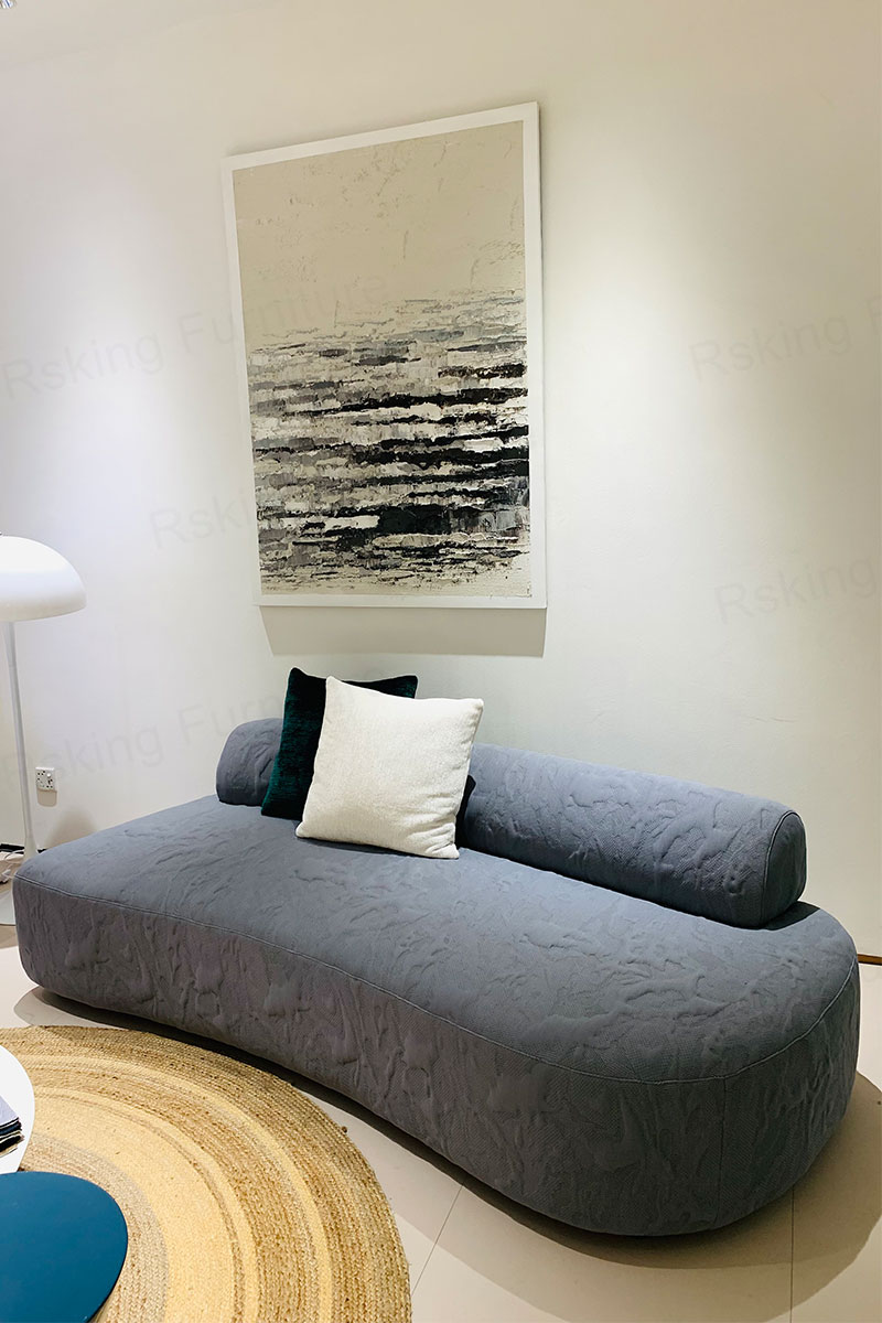 Angled view of the Rsking RSK2422 armless sofa showing its rounded base and elongated low backrest
