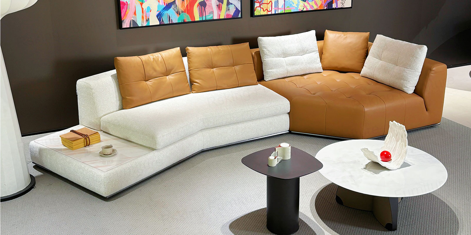 Angled showroom view of the Rsking RSK2518 showing contrasting upholstery and a marble surface integrated into the sofa end