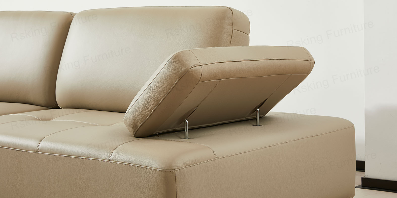 Side detail of the raised adjustable armrest above the cream leather base of the Rsking RSK13-B sofa